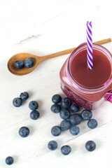 Fruit and blueberries juice on white board