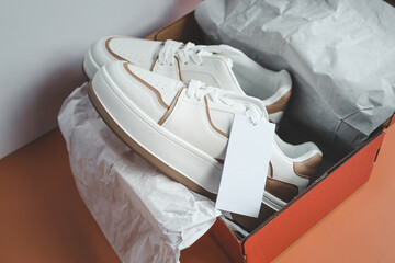 Stylish pair of women's sneakers with a label, a place for your logo