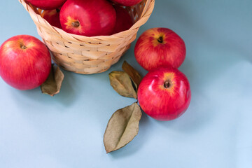Top view of juicy red apples on blue background, close up.