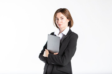 Young attractive and smiling business woman in black suit holding gadget isolated on white. Copy space and place for text concept