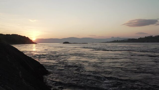 Sunset at strong tidal current Saltstraumen in Norway
