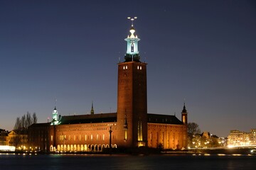 Fototapeta premium Beautiful scenery of illuminated Stockholm by night - town hall. Sweden