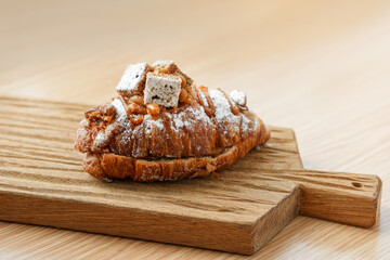 Delicious banana croissant on a wooden board