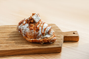 Delicious banana croissant on a wooden board