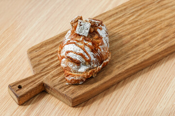 Delicious banana croissant on a wooden board