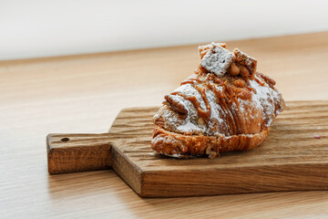 Delicious banana croissant on a wooden board