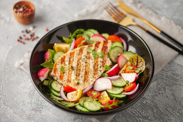 Juicy pork steak grill with vegetables in a plate on the table.