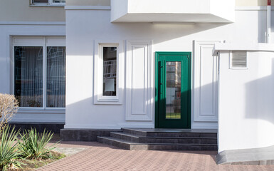 establishment exterior with white walls and green door, mockup design