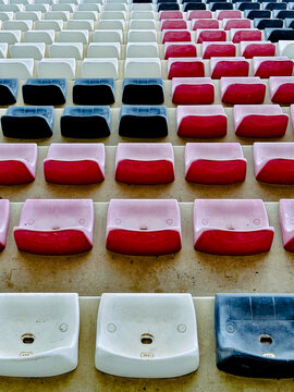 Overhead view of rows of red, white and blue plastic chairs