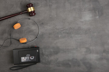 Music piracy and copyright protection law concept, gavel, tape recorder and headphones on table
