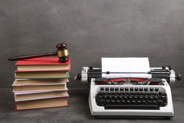 Writers desk - typewriter, books and judge's gavel, copyright protection law concept - 592375619