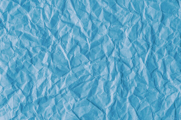 Recycled crumpled blue paper texture background. Wrinkled and creased abstract backdrop, wallpaper with copy space, top view.