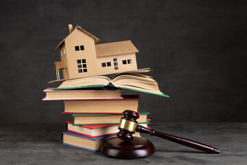 House model, gavel and books on the desk, Real property law concept, real estate auction - 592376261