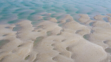beach sand at low tide, top view. Unusual sandy texture.