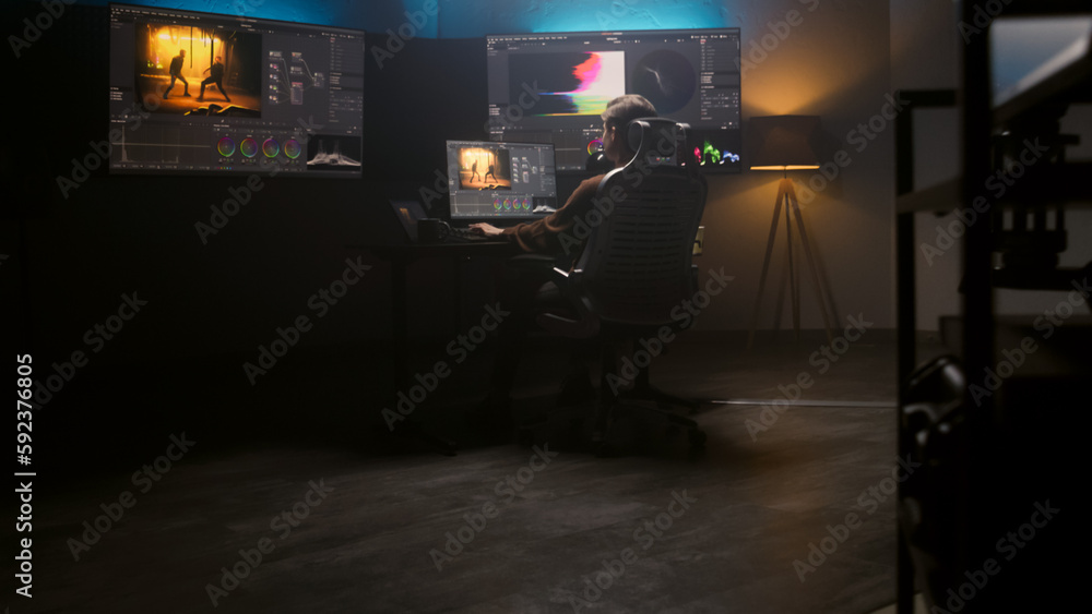 Poster female editor works in studio on computer using color grading control panel and professional video e