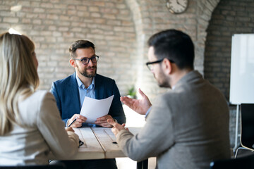 Broker manager talking with client at office