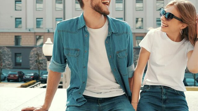 Portrait of smiling beautiful girl and her handsome boyfriend in casual hipster summer clothes. Happy cheerful family having fun on the street background 