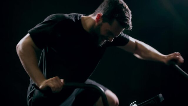Man doing fitness training on bike at gym, workout for sports motivation and cardio exercise for strong body. Face of person with testosterone getting healthy and moving for wellness and health
