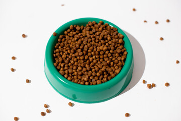 Cat's feed on green bowl on white background, food for breed cats