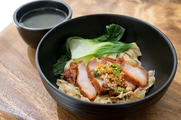 egg noodle with red roasted pork and bok choy- Asian food style.
