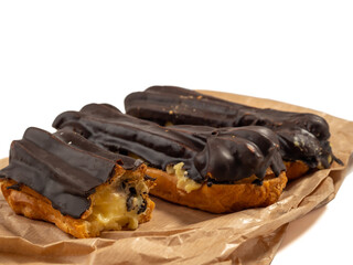 Delicious chocolate eclairs isolated on white background. Eclairs Close-up.