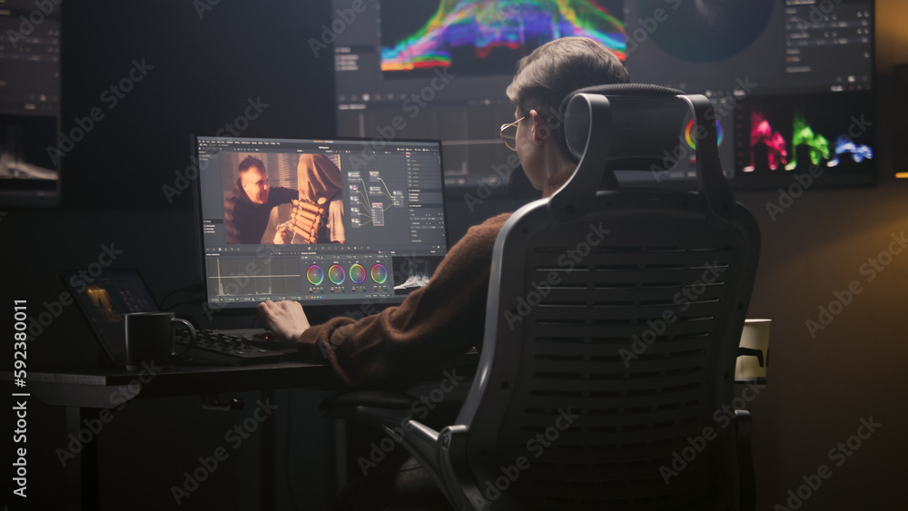 Poster female editor works in modern studio on computer using professional editing software. woman edits vi