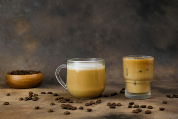 Tasty ice coffe with milk and cappuccino in glasses in dark background.