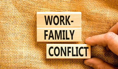 Work-family conflict symbol. Concept words Work-family conflict on wooden block on a beautiful canvas table canvas background. Businessman hand. Business work-family conflict concept. Copy space.