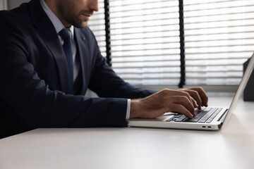 Side View of Businessman  Hands Using Laptop at Office