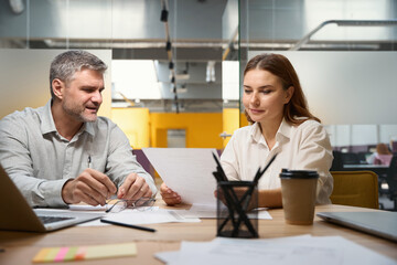 Man and woman discussing contract in the office
