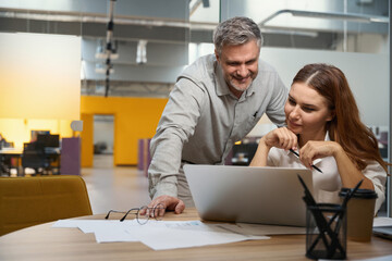 Male and lady discussing work process in the office