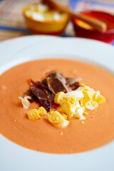 Salmorejo served with jamón and boiled egg, refreshing Spanish tomato cold soup from Cordoba, Andalusia, Spain