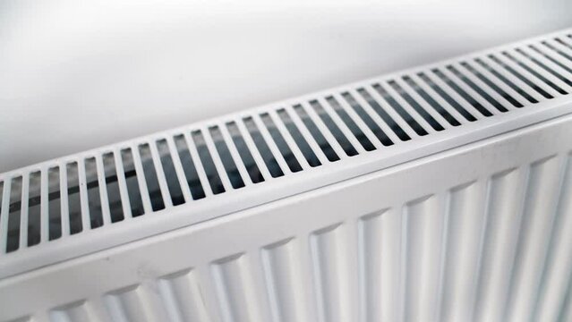 Modern home heating convector indoor warming white grid radiator climate control closeup