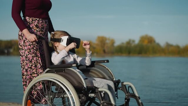 Girl with spinal cord injury plays game in VR glasses