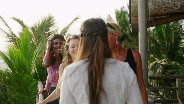 Cheerful multiracial girls take selfies on vacation. Diverse young women taking self portraits with smartphone. Multiethnic happy female friends taking photos smiling and laughing on exotic location