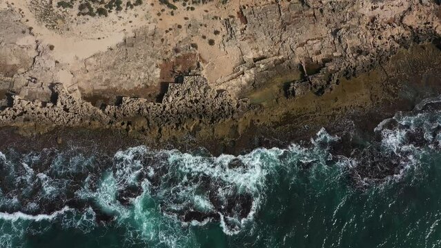 Aerial view of a beach in Israel and a wave with rocks 