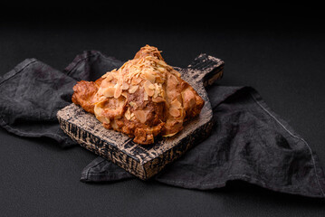 Fresh crispy croissant with almond chips and chocolate filling