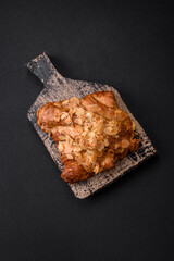 Fresh crispy croissant with almond chips and chocolate filling