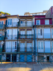 Old, colorful closed buildings in Porto, Portugal close to the Douro, Alfandega. Image taken on a sunny day in April.