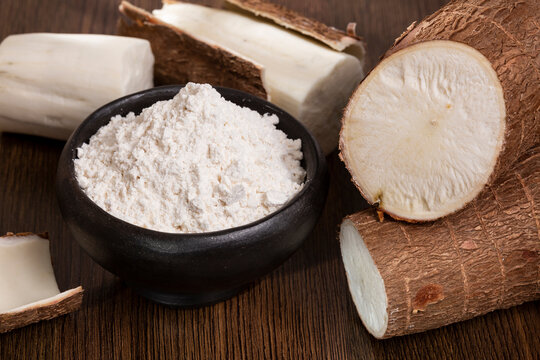 Raw Cassava Root And Starch - Manioc Esculenta; On Wooden Background