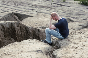 A man surrounded by mountains. Thoughtfulness and loneliness