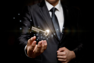 Businessman holding the key to success .