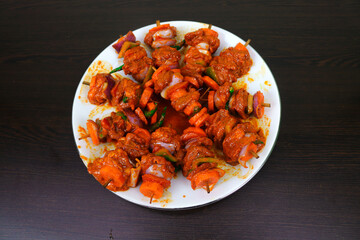 Tasty Chicken Shashlik, Juicy Onions, Spicy Green Chilies, Crisp Carrots, Colorful Peppers, and Capsicum, Skewered and Grilled to Perfection, Drizzled with Flavorful Oil, and Ready to be Savored.