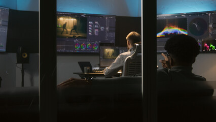 Multi ethnic colorist and film maker edit movie and make color grading in professional software....