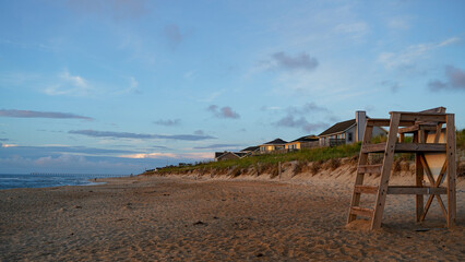 Fototapeta na wymiar Morning dawn at the beach with homes and seagrass