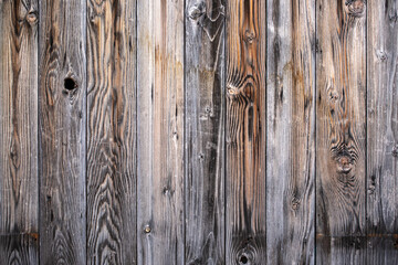 Background of old brown and grey faded boards close up, grey fence. Textures. Wallpapers. Weathered