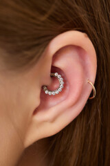 piercings on an ear. Conch and helix piercings close up.