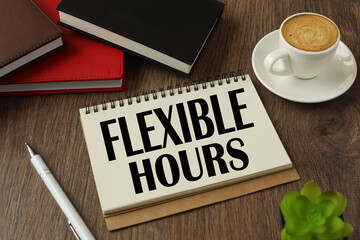 FLEXIBLE HOURS. Office table with flower, blank notepad and coffee cup.
