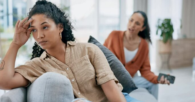 Lesbian couple, divorce and conflict, argument or fight in living room dispute or disagreement on sofa at home. Upset and angry LGBTQ women in toxic relationship, issues or fighting after breakup