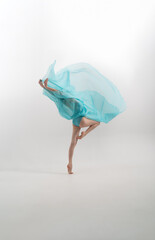 young ballerina dancing with fabric. tan.